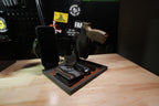 Gray tactical EDC tray with a brown liner, displayed with a phone, holstered pistol, magazine, wallet, watch and keys.