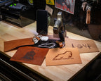 FDE tactical EDC valet tray with pistol stand, iPhone and Apple Watch charger, and multiple leather liner options with custom engraving examples