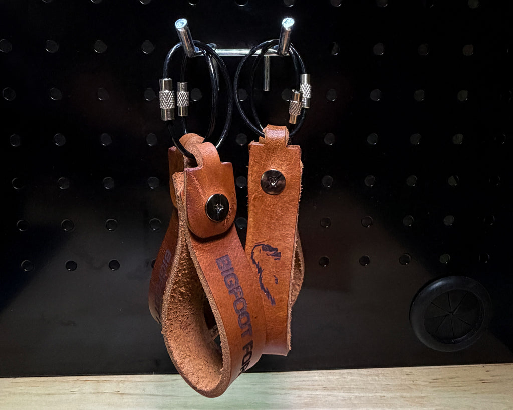 Bourbon leather keychains with engraved design and coated stainless steel cable rings on display