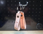 Leather keychains in veg tan  with engraved designs and coated steel cable rings