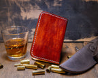 Angled exterior of the Bourbon vertical wallet showing the hand-dyed color variation and topographic engraving.