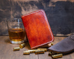Forgehand Field Bourbon vertical leather wallet with a hand-dyed amber and reddish-brown gradient and contrast stitching.