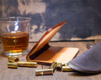 Side view of the Bourbon vertical wallet showing its folded construction, leather edges and stitching.