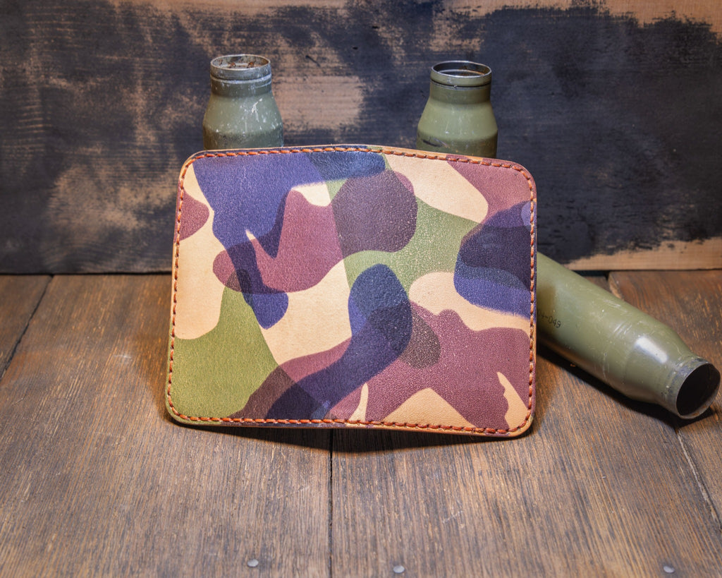 Woodland Camo wallet opened flat to show the full camouflage leather exterior and orange stitching.