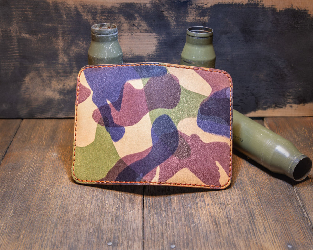 Woodland Camo wallet opened flat to show the full camouflage leather exterior and orange stitching.