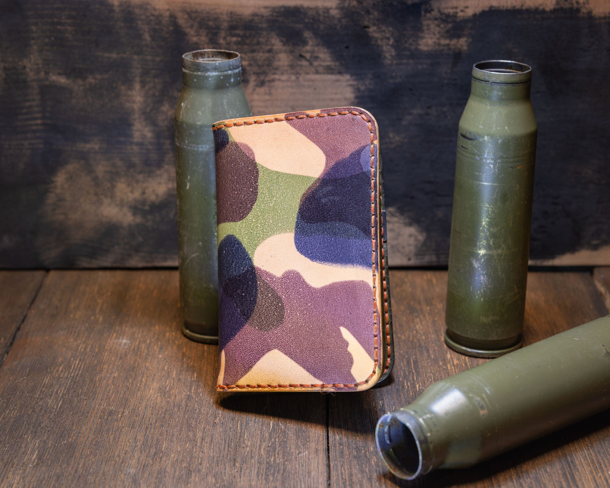 Forgehand Field Woodland Camo vertical leather wallet with a camouflage exterior and orange contrast stitching.